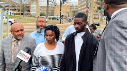 Michael Jenkins, second from right, stand with his mother, Mary Jenkins, center, and their attorneys at a news conference Wednesday, Feb. 15. 2023, in Jackson, Miss., following his release from the hospital three weeks after being shot by sheriff's deputies. The Justice Department says it has opened a civil rights investigation into the Rankin County Sheriff's Office after its deputies wounded Jenkins during a drug raid on Jan. 24. Jenkins says he was beaten and shot in the mouth unjustifiably. The sheriff says Jenkins was charged with assaulting an officer and drug possession. (AP Photo/Michael Goldberg)